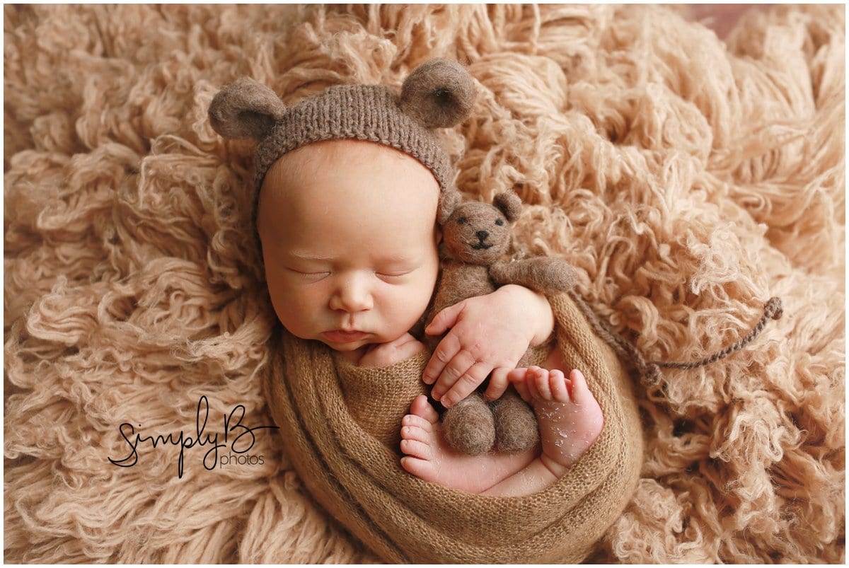 edmonton newborn baby on brown rug with teddy bear