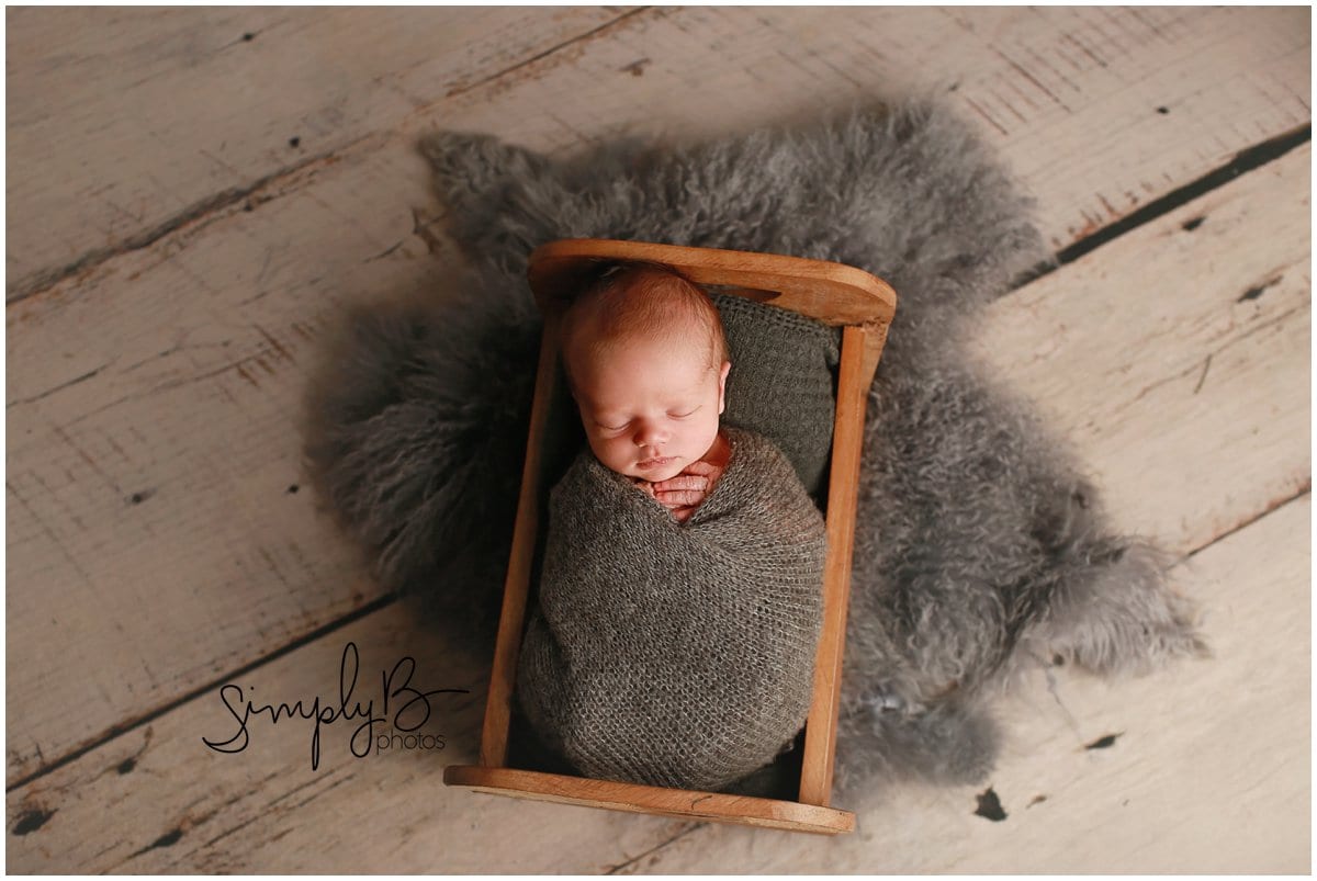 edmonton newborn photographer baby boy in a bed prop